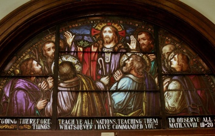 Stained glass church window of Jesus speaking to his disciples