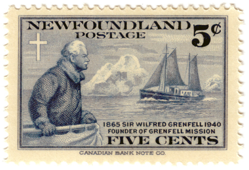 Postage stamp with drawing of missionary Greenfell looking at a sailing ship with an iceberg behind it