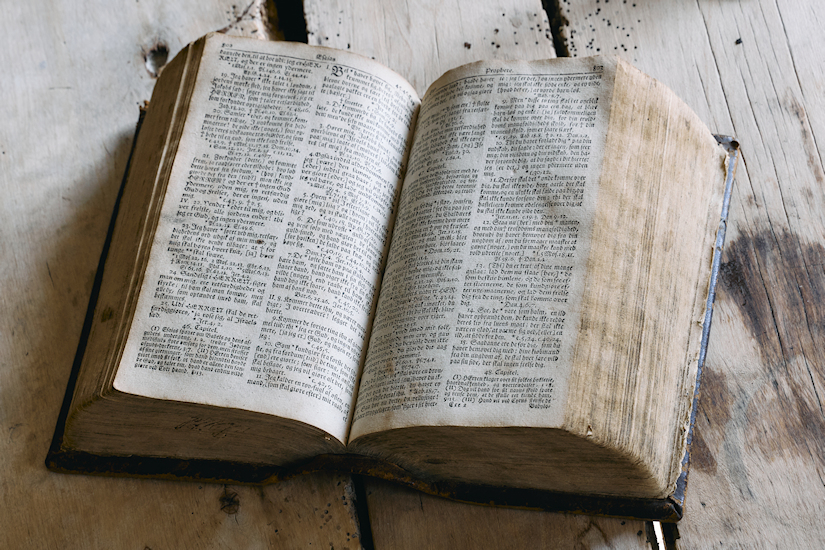 Open Bible lying on a wooden table