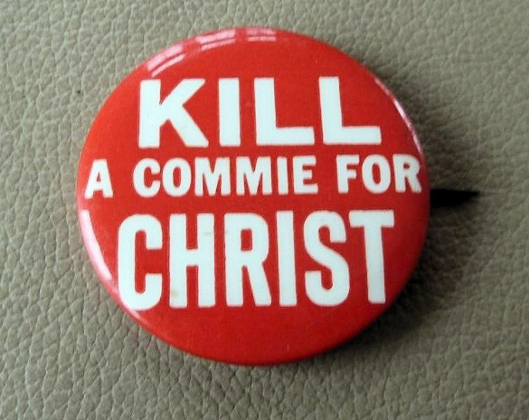 lapel button with kill a commie
slogan on it