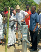 photo of Elgin Taylor at
a water well in Africa