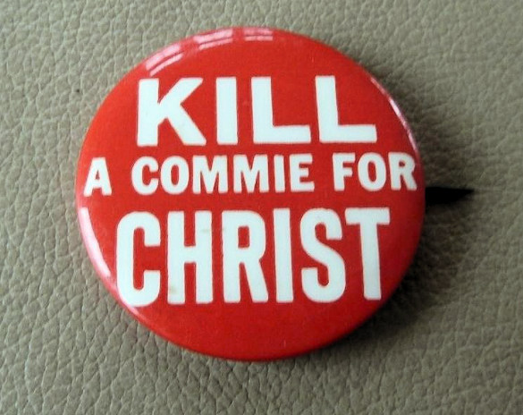 lapel button with kill a commie
slogan on it