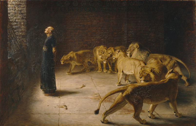 Daniel standing in a rock cave filled with lions