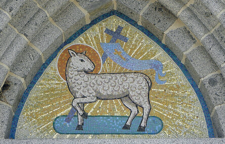 Mosaic of a lamb with a halo giving off light. There is a cross and a banner attached to it