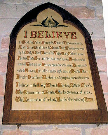 Apostles' Creed wording on plaque on stone wall
