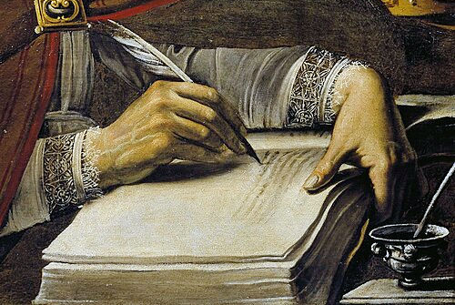Hand writing with a quill in a book