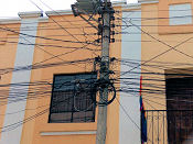 photo of jumble of
overhead wiring above street