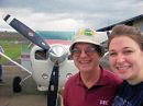 photo of two people in front
of single-engine airpalne
