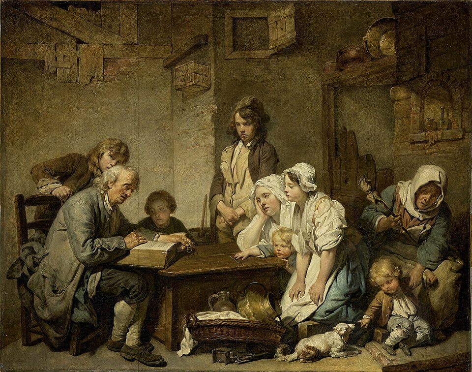 Father at table reading the Bible to family gathered around