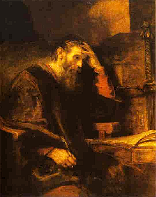 Man sitting at a table writing a letter using a quill