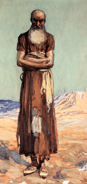 Elderly man with long white beard standing with arms crossed