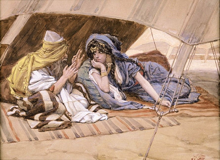 Man and woman talking in the shade of a tent