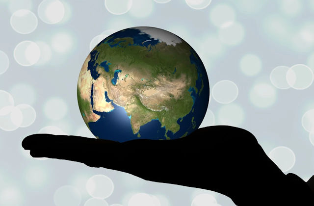 globe showing Asia in the palm of a human hand