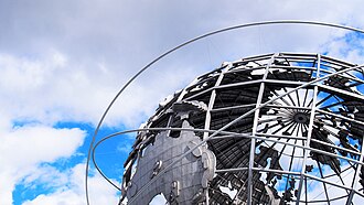 a huge hollow metal globe structure that is also a water fountain