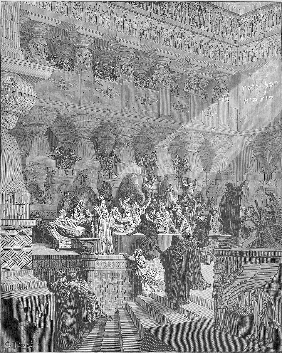 Daniel standing before king and his advisors and pointing to Hebrew writing on the wall above